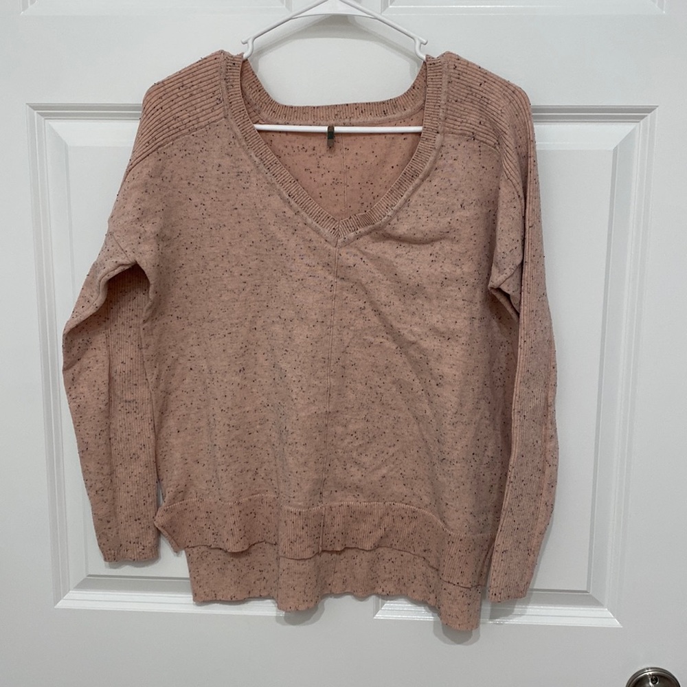 Light pink lightweight sweater with small black splatter. Size large.